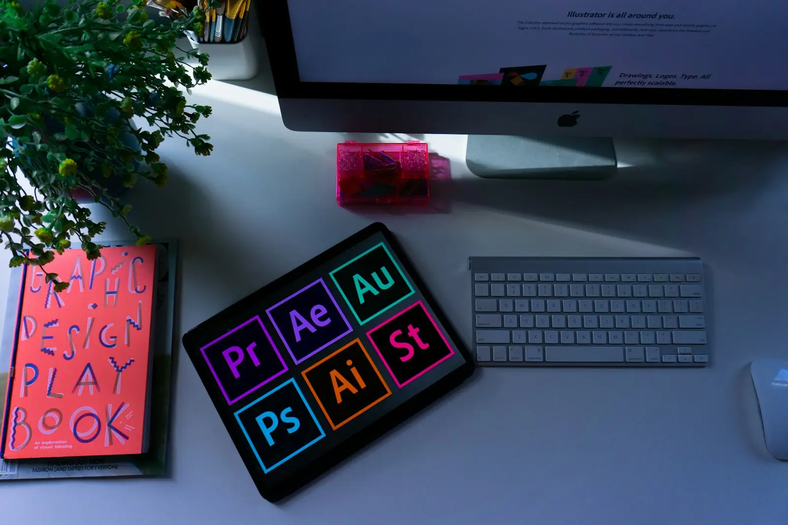 Design playbook beside creative tools on a desk